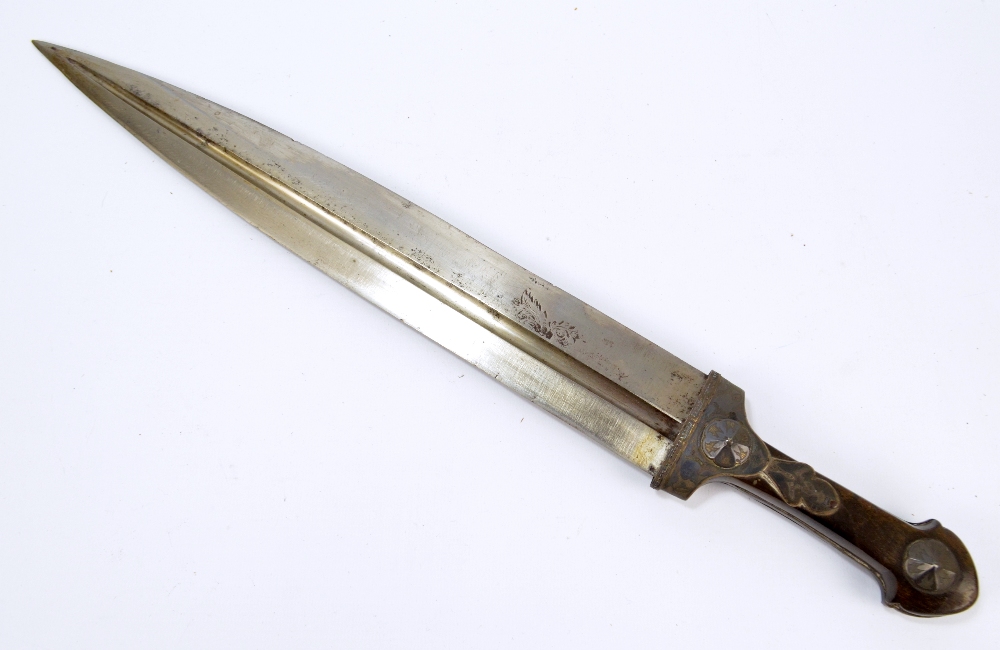 A 19th century dirk with shaped wooden handle set with engraved metal mounts and fluted blade