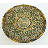 A late 18th/early 19th century Persian footed shallow bowl, decorated in shades of green,