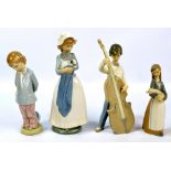 Three Lladro figures to include a boy playing double bass and a Nao figure of girl with puppy (4).