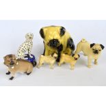 A group of six various ceramic figures of dogs to include a Staffordshire type dalmatian and two