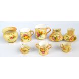 A group of Royal Worcester blush ivory pieces to include a miniature loving cup marked in puce,