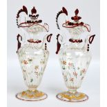 A pair of small contemporary Milanese glass ewers with applied ruby detail,