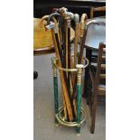 A simulated malachite and brass mounted circular stick stand containing a quantity of decorative