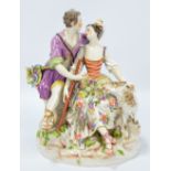 A Meissen figure group of shepherd courting shepherdess with sheep alongside,