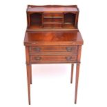 A 19th century mahogany and inlaid bonheur du jour, with foldover top above two long drawers,