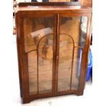 An early 20th century glazed display cabinet raised on bracket feet, height approx 124cm.