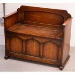 An Edwardian oak bench with box seat, width 91cm.