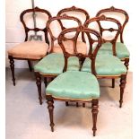 A set of six Victorian walnut balloon-back dining chairs,