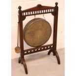 An Edwardian mahogany dinner gong with brass gong, turned bobbin spindle decoration,