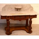 A late Victorian walnut wash stand with marble top and splash back,