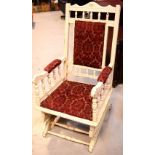 A late 19th/early 20th century painted mahogany American rocking chair with upholstered seat and