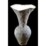 FREYA BRAMBLE-CARTER; a tall stoneware vase with flared neck, partially covered in eruptive glaze,