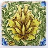 WILLIAM DE MORGAN; a square sectioned tile painted with a stylised yellow flower,