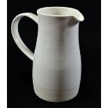 KEITH BRYMER JONES; a large white stoneware jug with strap handle, impressed mark, height 19cm.