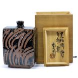 SHOJI HAMADA (1894-1978); a rectangular stoneware bottle, wax resist tenmoku and khaki glaze,