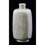 WILLIAM MARSHALL (1923-2007); a square porcelain bottle, roughly faceted, covered in pale celadon,