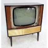 A vintage HMV television in cabinet with sliding tambour doors and raised on square sectioned