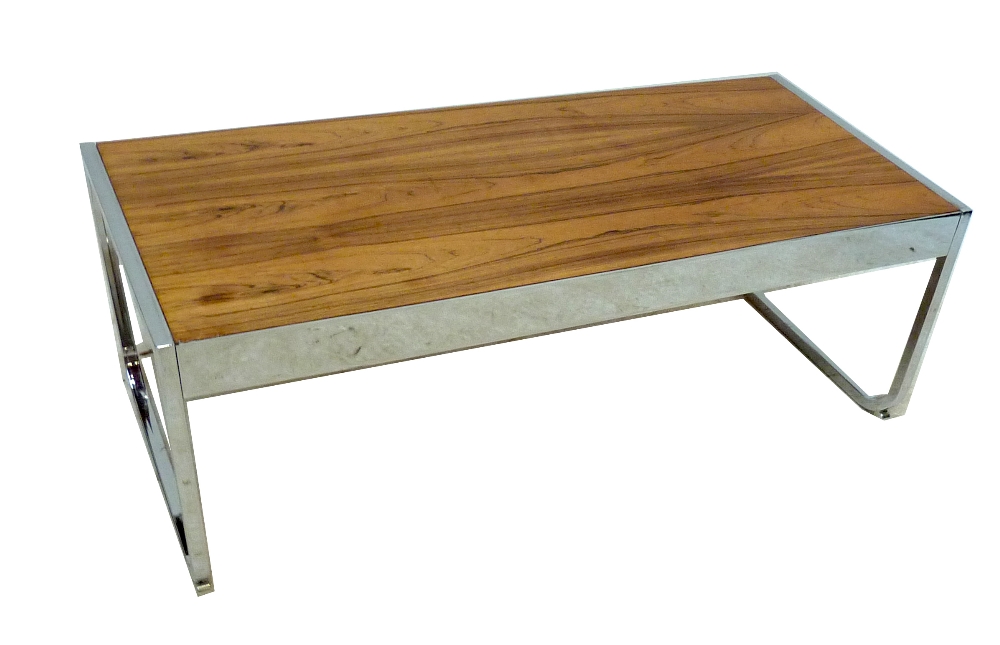 A rosewood and chrome coffee table raised on shaped end supports, attributed to Herman Miller.
