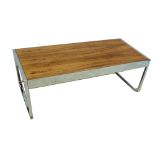 A rosewood and chrome coffee table raised on shaped end supports, attributed to Herman Miller.