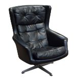 DUX OF SWEDEN; a 1960s black 'Egg' leatherette button padded easy wing back swivel chair,