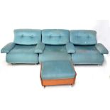 A sectional turquoise upholstered G-Plan lounge suite with two stools.