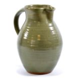 GEOFFREY WHITING (1919-1988) for Avoncroft Pottery; a stoneware jug covered in green glaze,