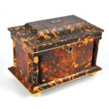 A 19th century tortoiseshell tea caddy with a hinged sarcophagus lid and cylindrical columns to