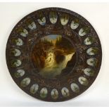 A late 19th century Black Forest carved oak circular table top painted with a waterfall to the