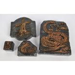 Four printing blocks of varying sizes,