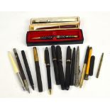 A collection of vintage fountain pens including Parker Slimfold,