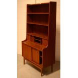 A mid-20th century teak Danish bureau bookcase, the fitted interior set behind two tambour doors,