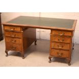 A late 19th/early 20th century walnut twin-pedestal desk,