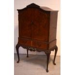 A mid-20th century burr walnut Epstein-style cocktail cabinet with fitted interior,