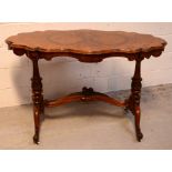 A 19th century burr walnut shaped loo table with shaped and carved under-stretcher,