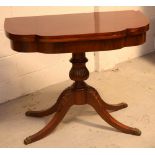 A reproduction Regency-style fold-over tea/card table.