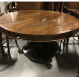 A George III rosewood loo table on circular central support to carved leaf design on circular base