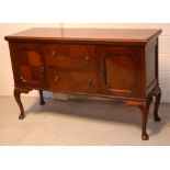 A reproduction mahogany sideboard, two large central drawers with cupboard door to either side,