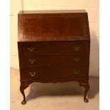 An early 20th century mahogany bureau with interior pigeonholes over three drawers to cabriole legs.
