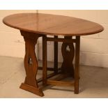 A 20th century oak gate-leg drop-leaf dining table in the Old Charm style,