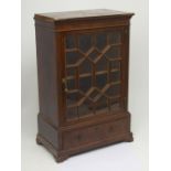 A flame mahogany desk-top bookcase of small proportions with a single astragal glazed door above