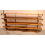 Four 20th century pine school benches by Continental Sports Huddersfield, length approx 267cm (4).