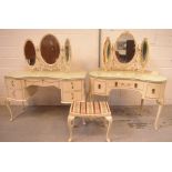 A mid-20th century cream kidney-shaped dressing table with gilt highlights,