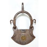 A 19th century Eastern iron ornamental stirrup with engraved foliate scrolls and centred with a