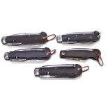 Five military clasp knives with moulded checkered pattern bodies with single blade,