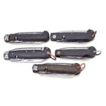 Five military clasp knives with moulded checkered pattern bodies, with single blade,