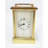 A 20th century brass carriage clock, the white dial set with Roman numerals and inscribed Ainsworth,