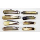 A collection of five early 20th century horn bodied single bladed pen knives including examples by