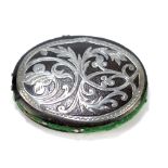 An oval silver overlaid pin cushion, with border of foliate and floral scrolls, with plain back,