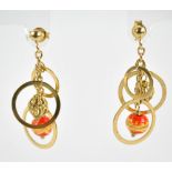 A pair of 9ct yellow gold drop earrings suspending three graduated hoops and two beads, length 4.