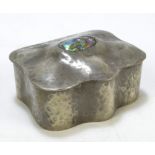 A pewter hammered decorated trinket box of shaped rectangular form,